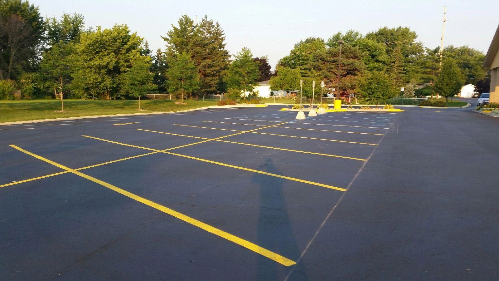 Asphalt parking lot with yellow line markings