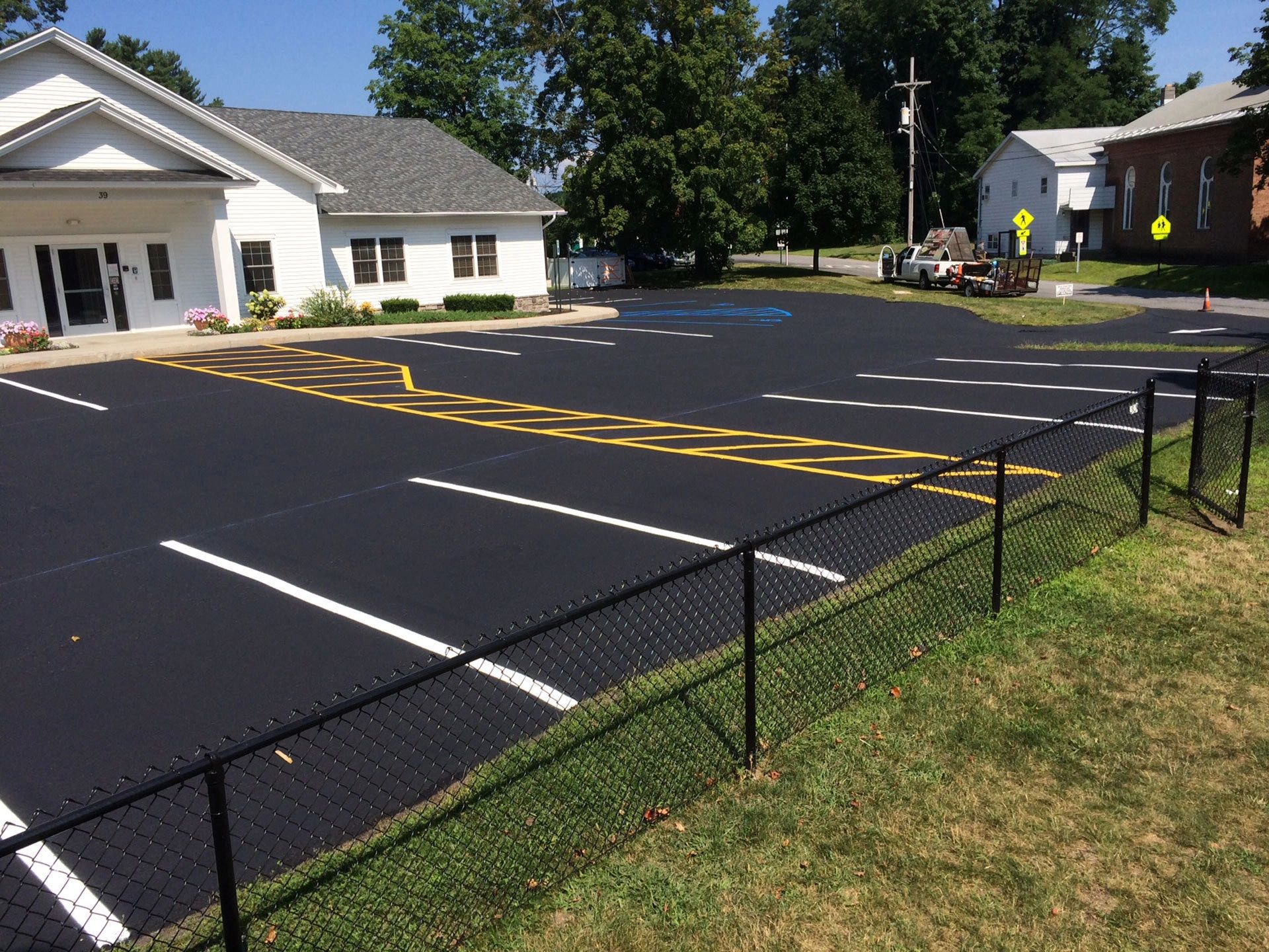 Newly paved parking lot with yellow and white line markings